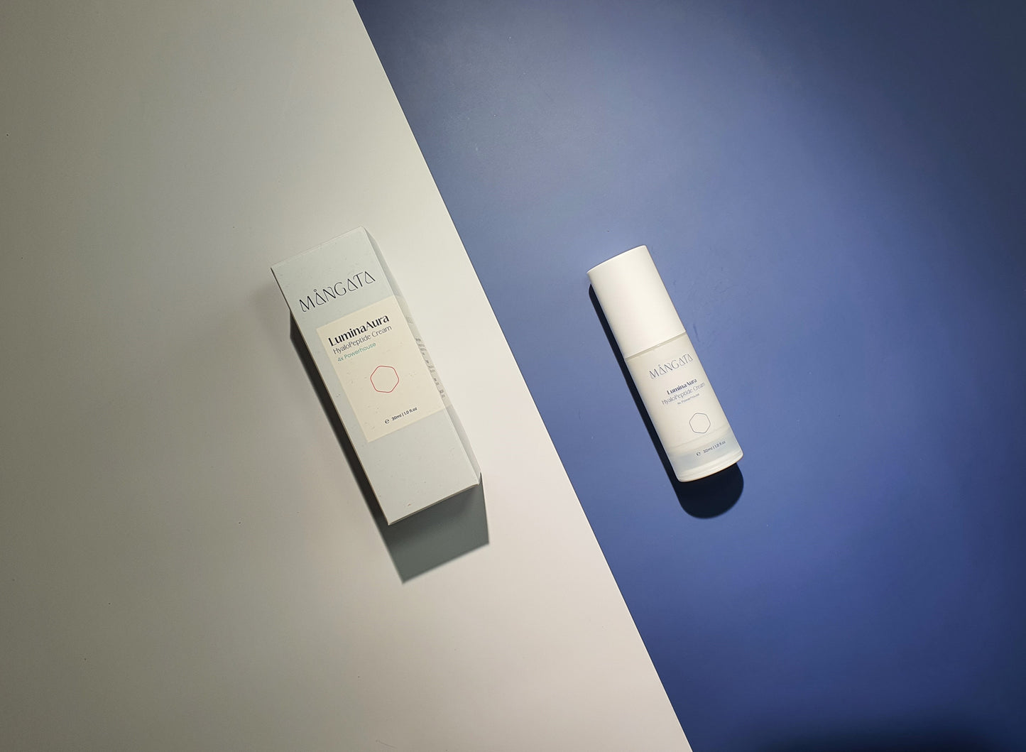 Elegant skincare plastic bottle and light blue box lying side by side on white and blue background.