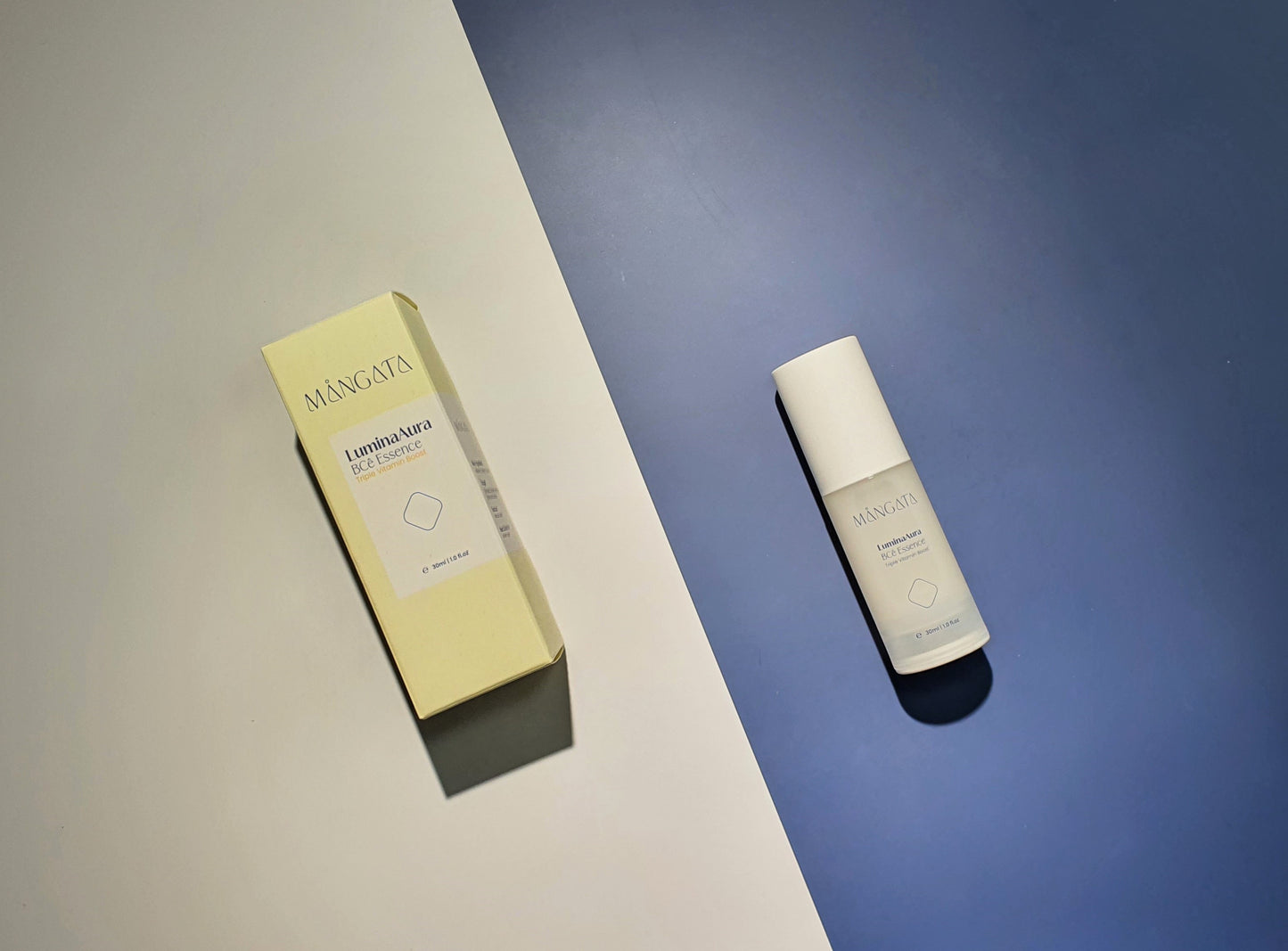 Elegant skincare plastic bottle and yellow box lying side by side on white and blue background.
