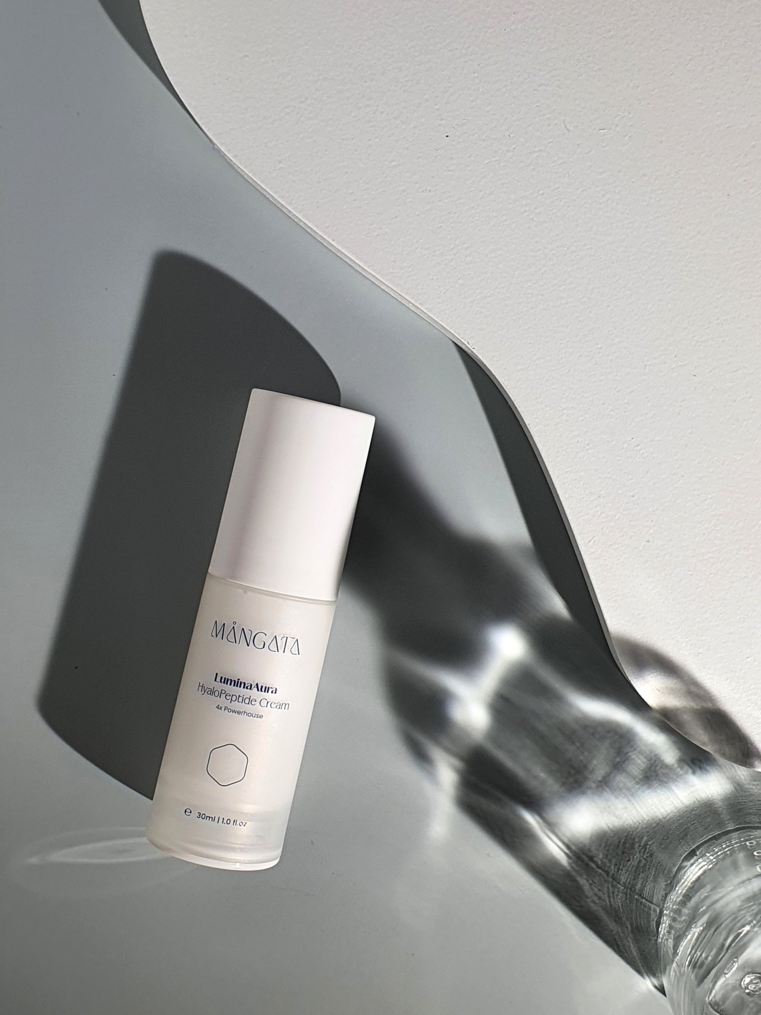 A brightening cream placed on a mint-colored background, with soft lighting.