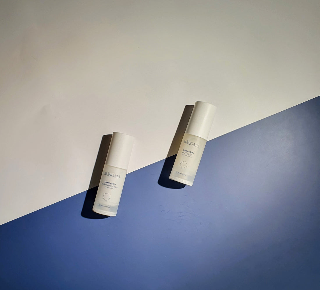 Two skincare bottles lying on simple nacy and white backround.