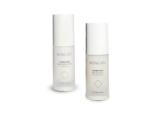 Two elegant bottle of vitamins hydrating essence and brightening cream, both with a white cap.